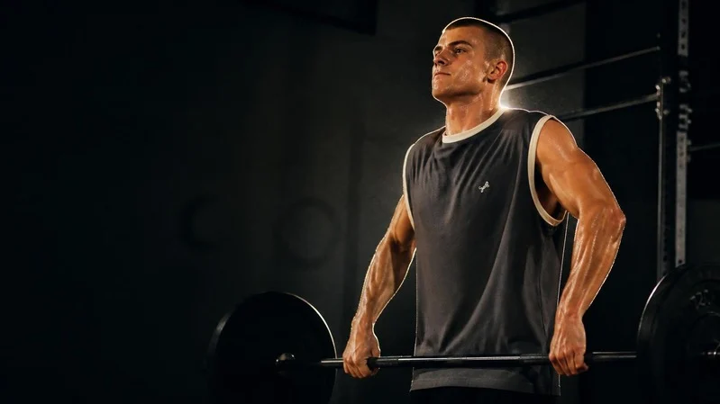 Man lifting a barbell wearing a Tiger Wolf contrast-trim tank